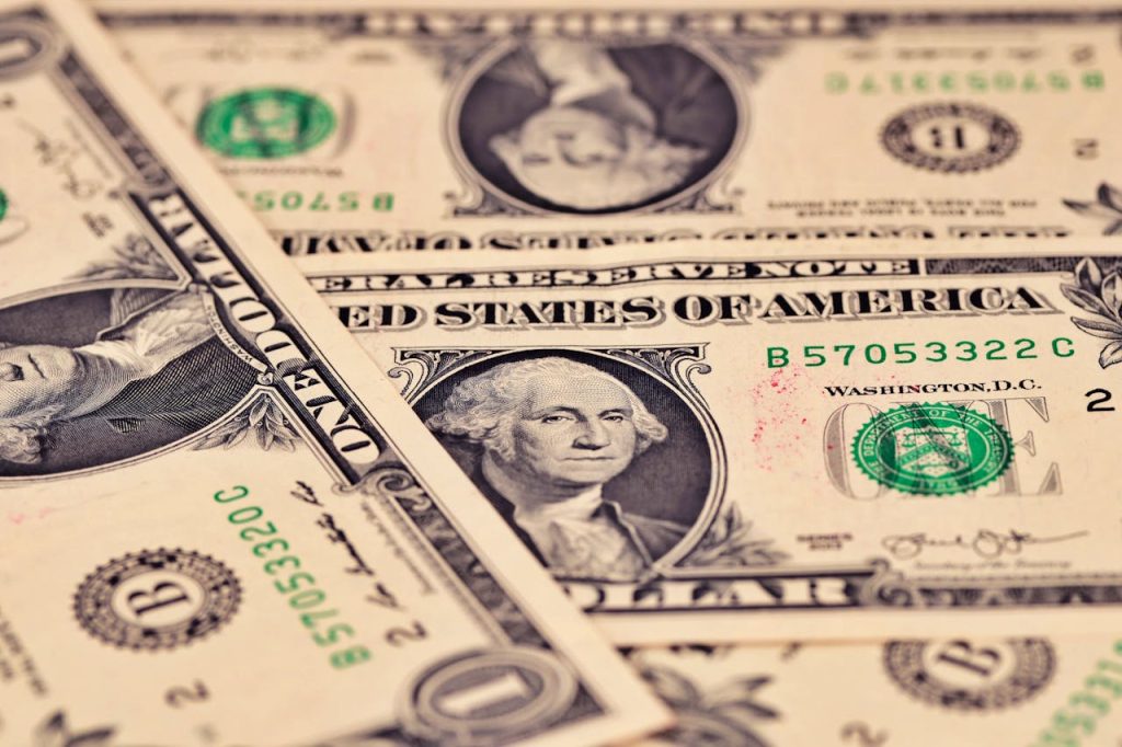 Detailed close-up of US one dollar bills showcasing intricate design and texture.
